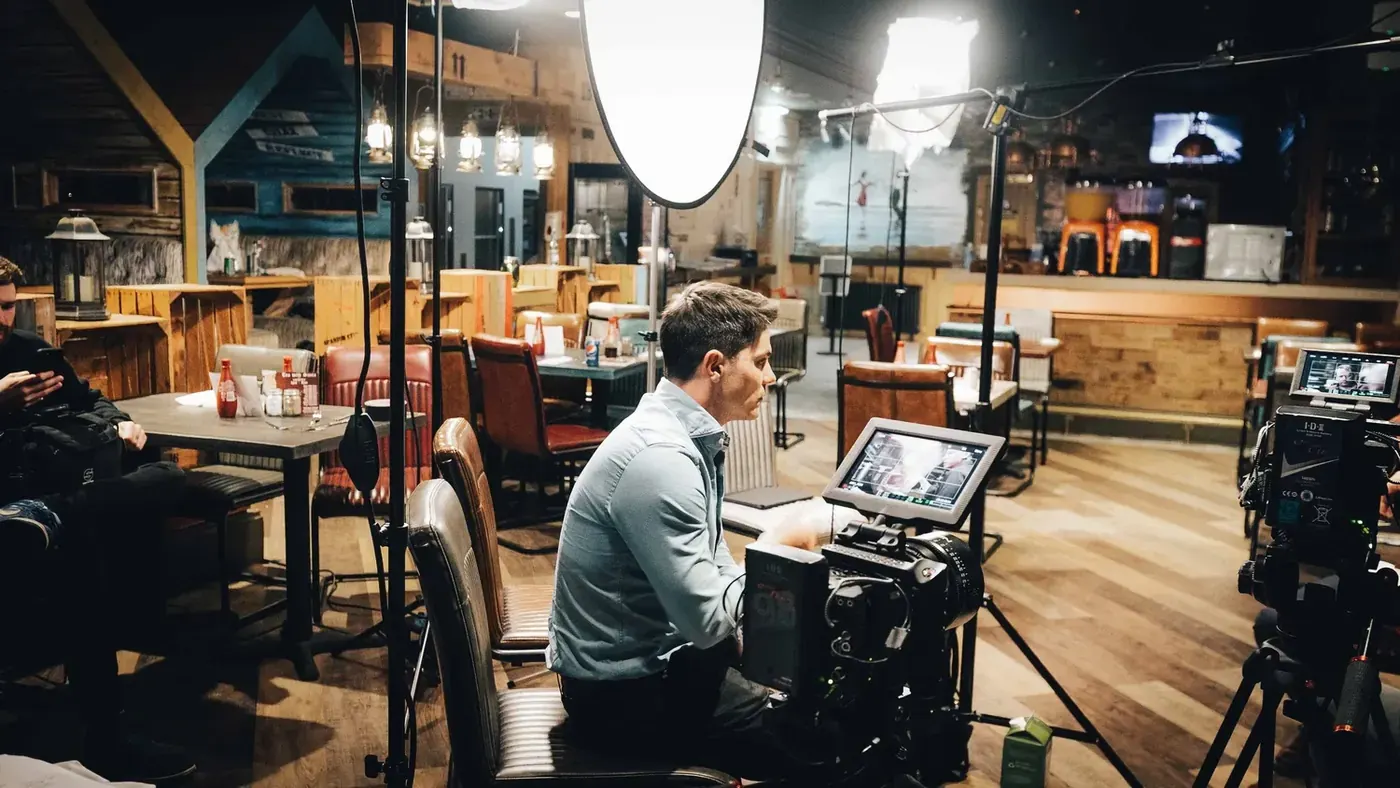 Rob Symes at the monitor on the edge of the restaurant set