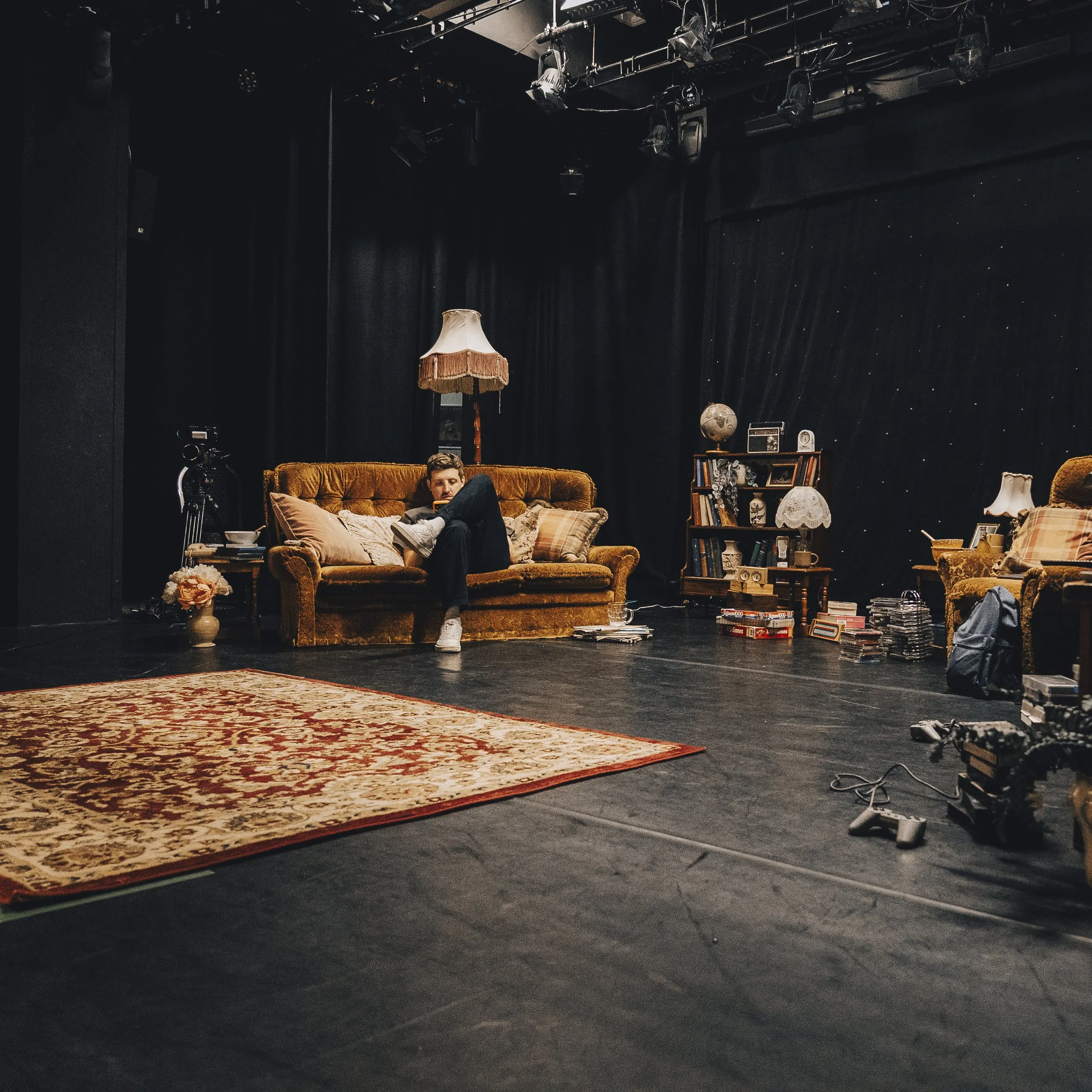 Mark G Smith lounging on the stage sofa between takes